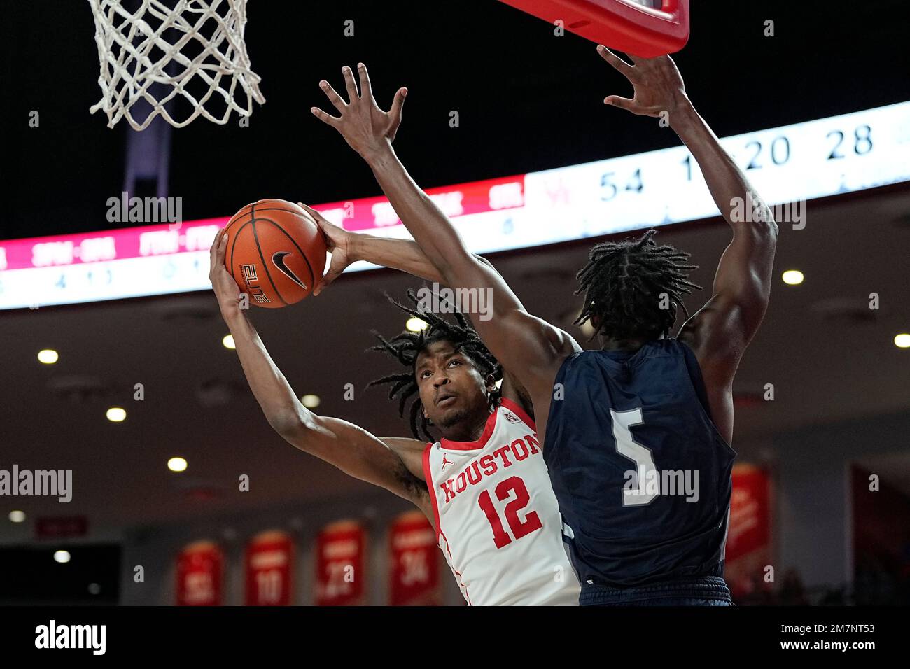 Houston guard Tramon Mark (12) is fouled by North Florida guard Dorian ...
