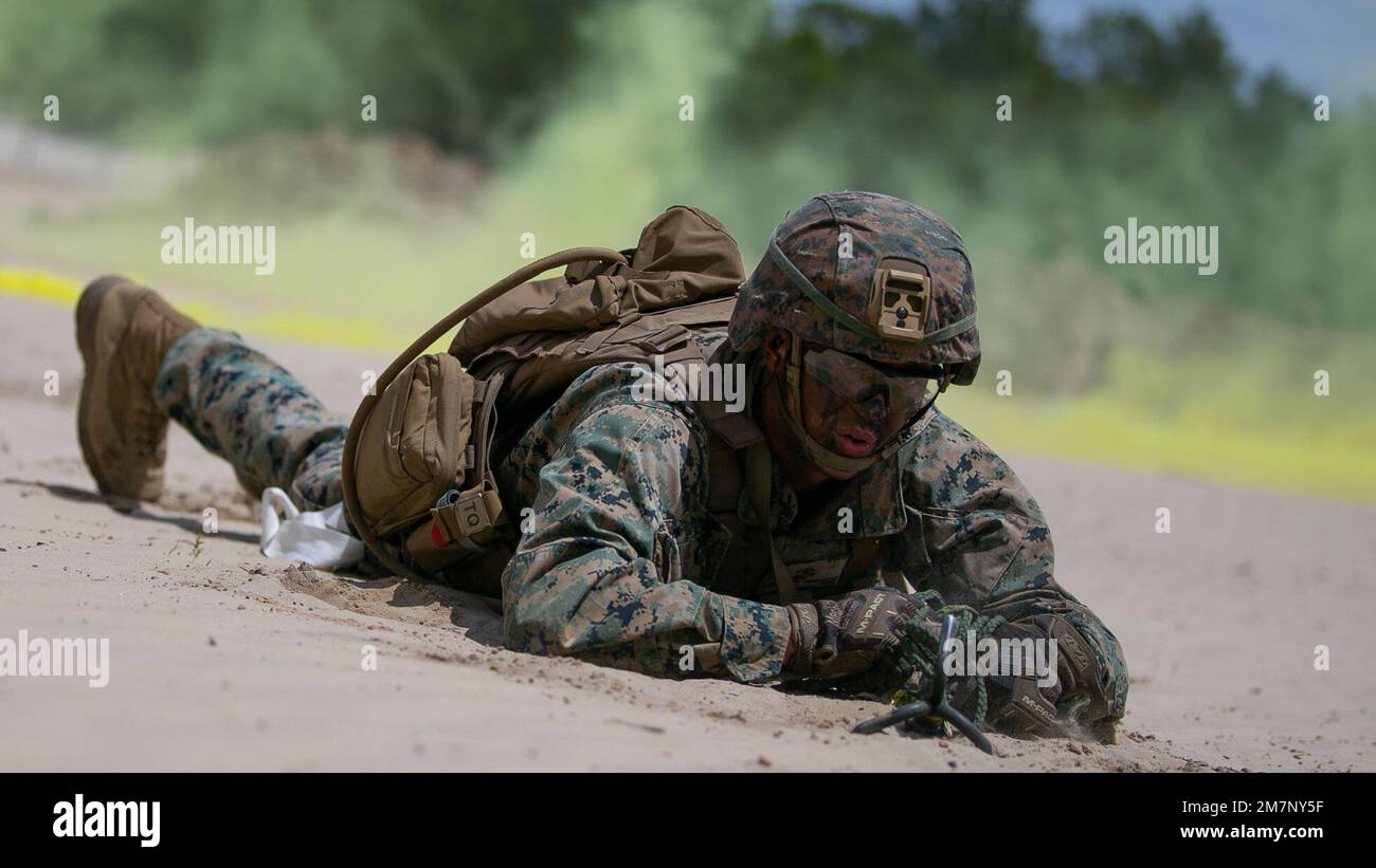A U.S. Marine with 2d Combat Engineer Battalion, 2d Marine Division,  retrieves his grappling hook during the Sapper Leaders Course on Camp  Lejeune, North Carolina, May 11, 2022. The Sapper Leaders Course