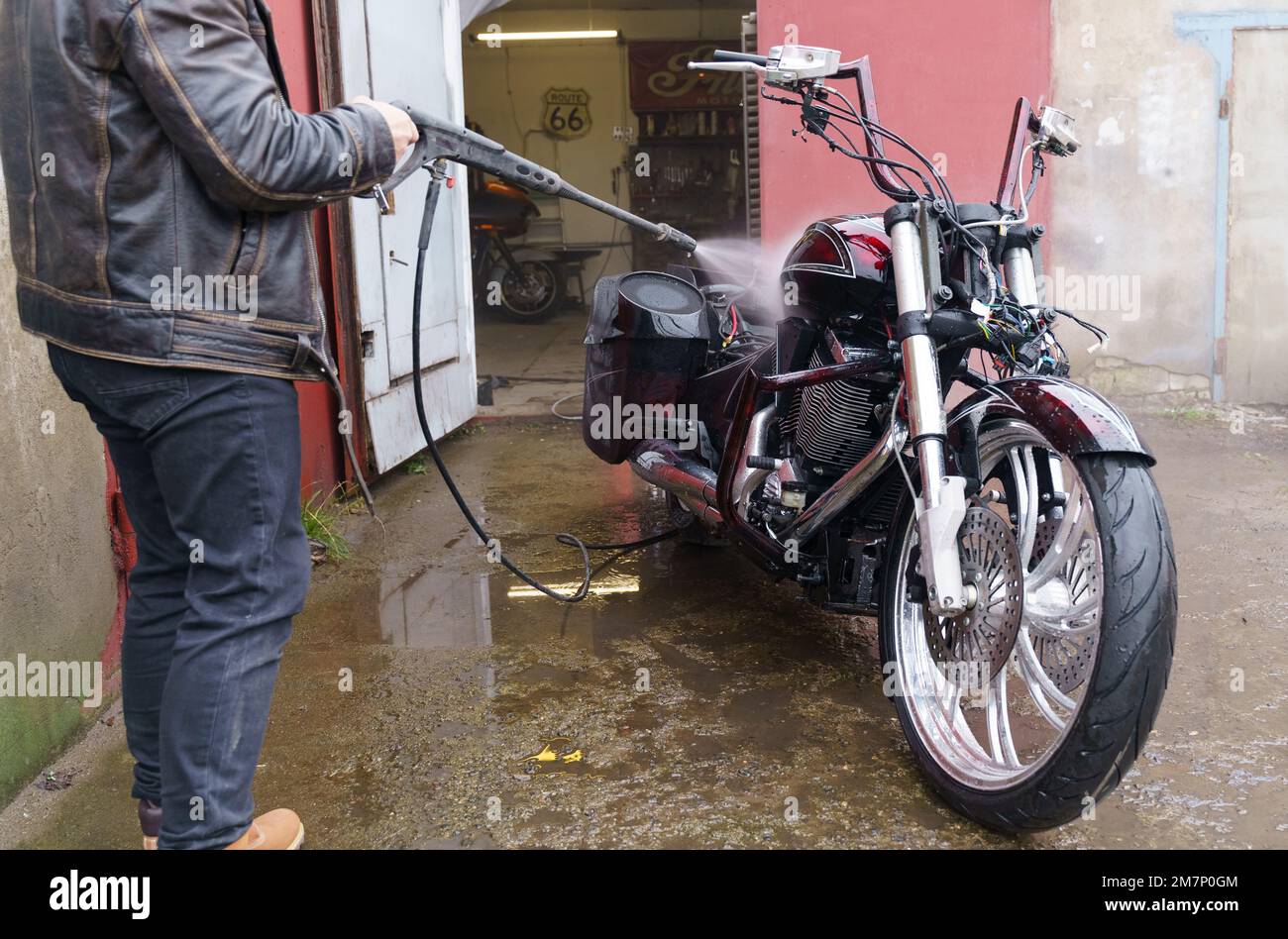 Washing a motorcycle engine with a high pressure jet. Closeup Stock Photo Alamy