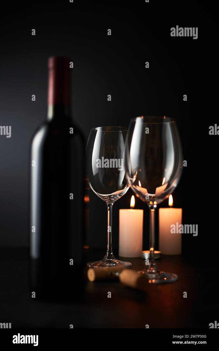 Empty Wine glass and Bottle on dark background. Stock Photo