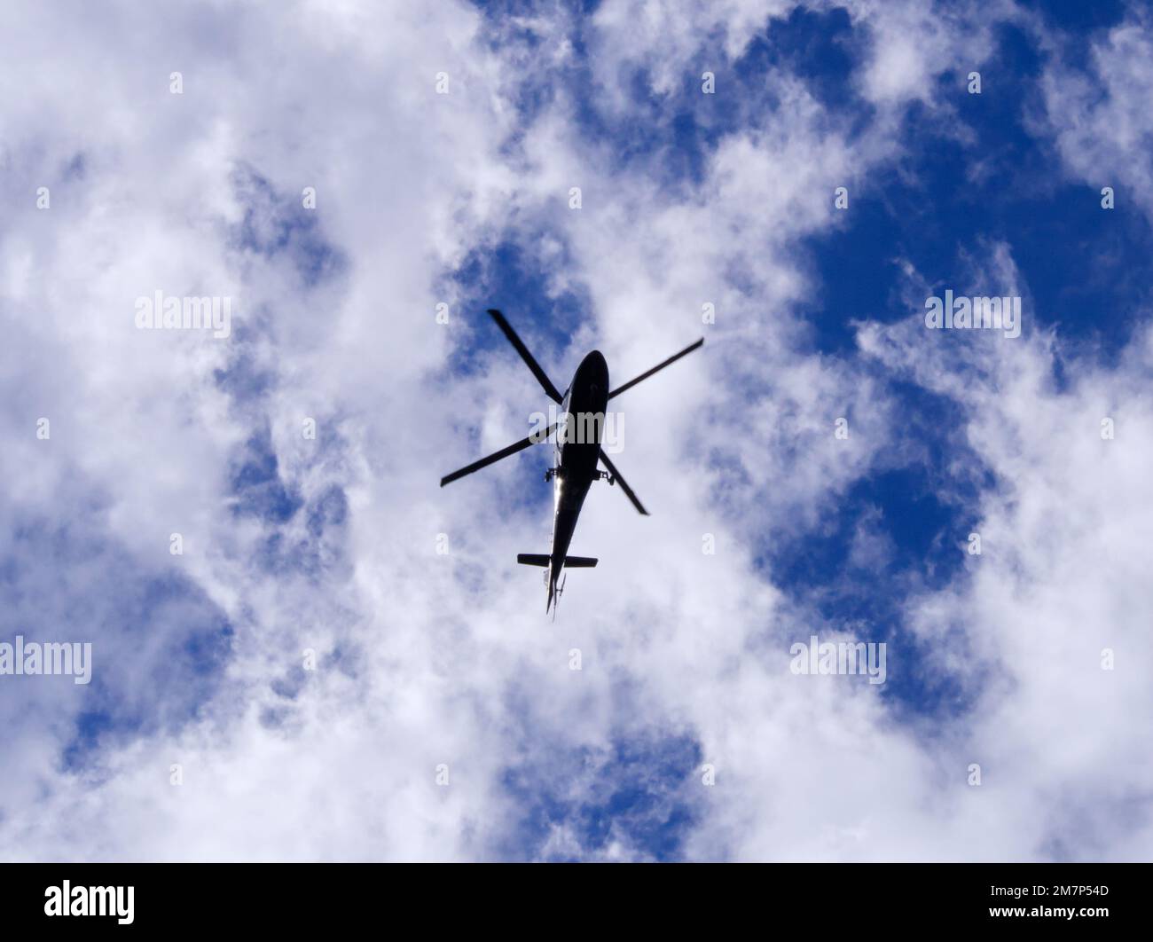 Helicopter bottom in cloudy sky Stock Photo