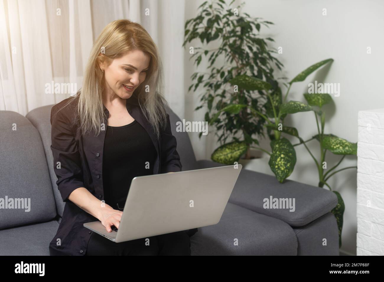 Smiling Young Woman Using Laptop Sitting On Couch At Home Beautiful Girl Shopping Or Chatting Online In Social Network Having Fun Watching Movie Stock Photo Alamy