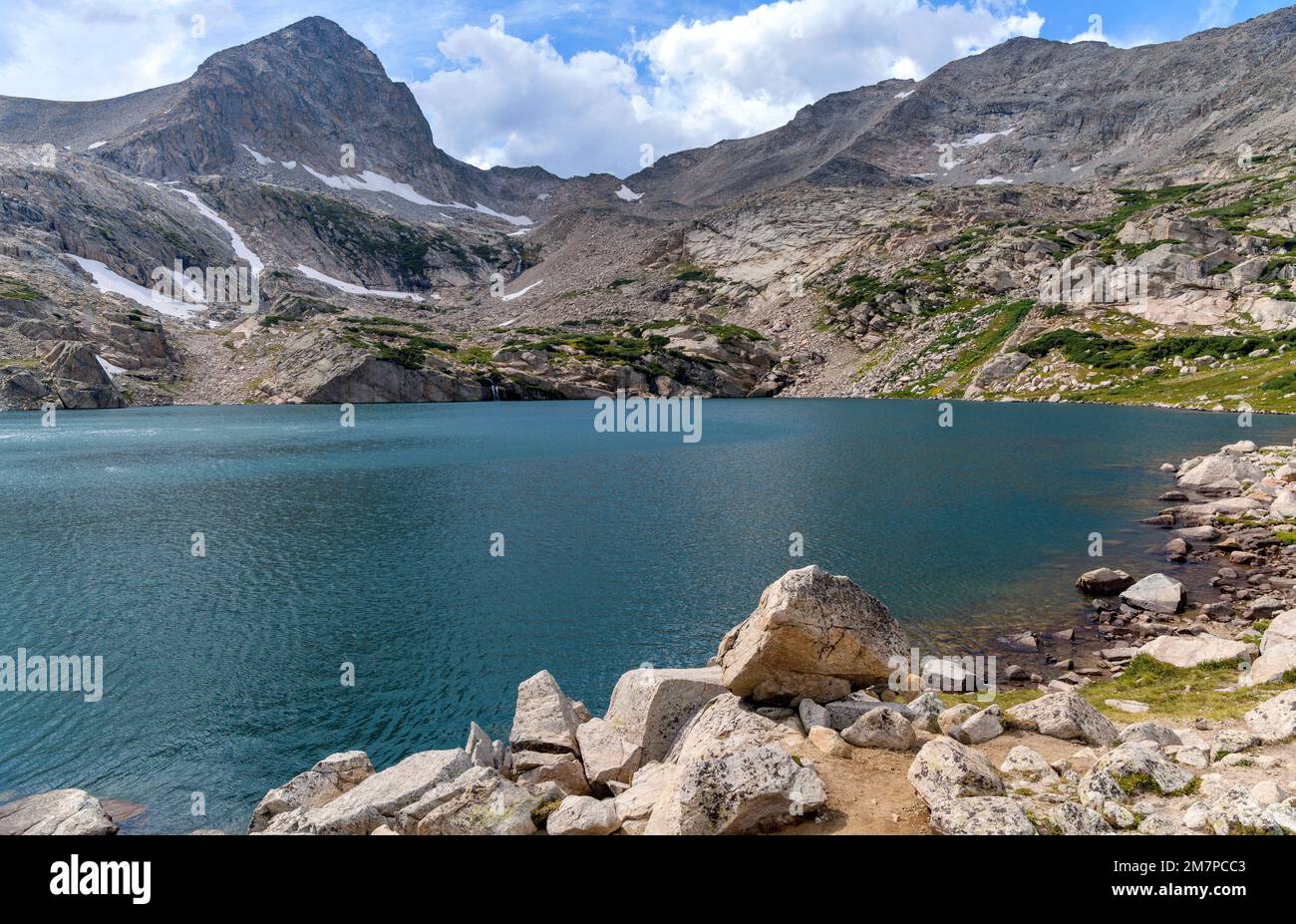 Blue Lake - A panoramic view of pristine Blue Lake at base of summit of Mount Toll on a sunny Summer afternoon. Indian Peaks Wilderness, Colorado, USA. Stock Photo