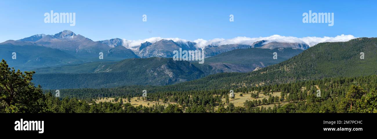Rocky Mountains - Panoramic view of northern Front Range mountains, leading by Longs Peak at left, on a Summer morning. Rocky Mountain National Park. Stock Photo