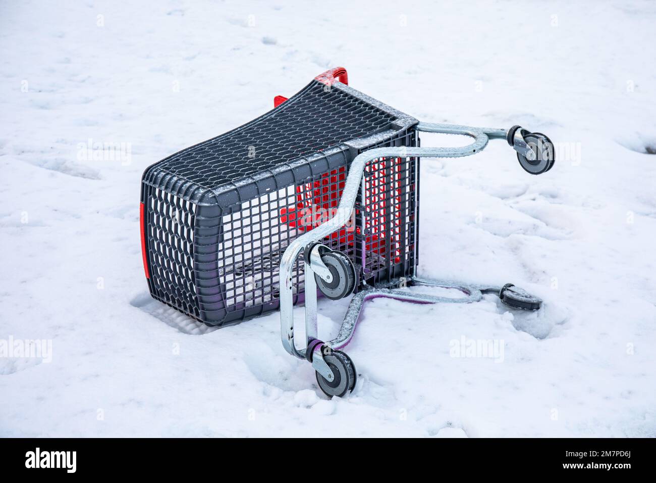 Overturned shopping cart of supermarket trolley in snow Stock Photo Alamy