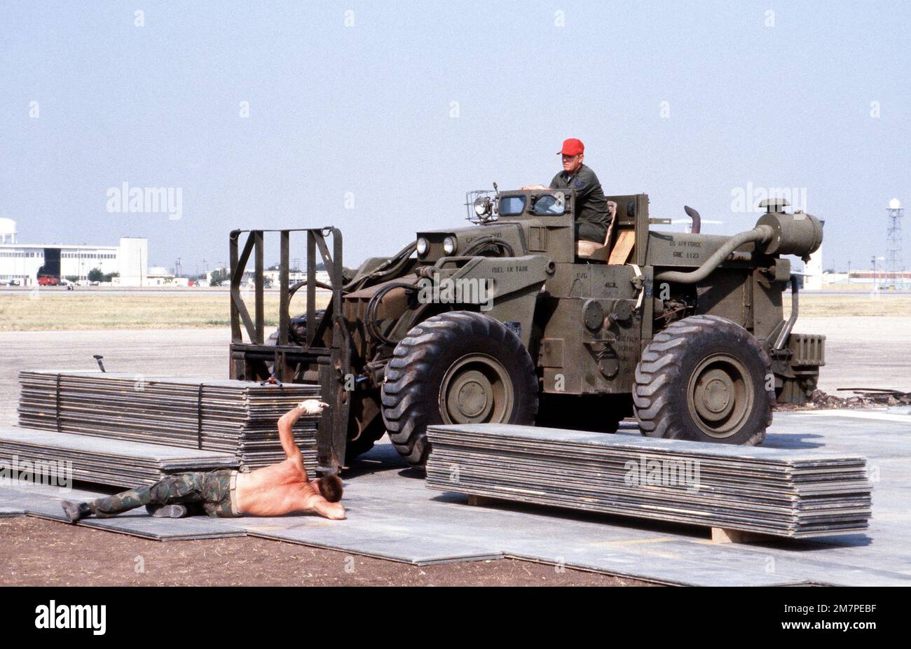 Marines install matting for a portable runway during a C5A Galaxy aircraft operational utility