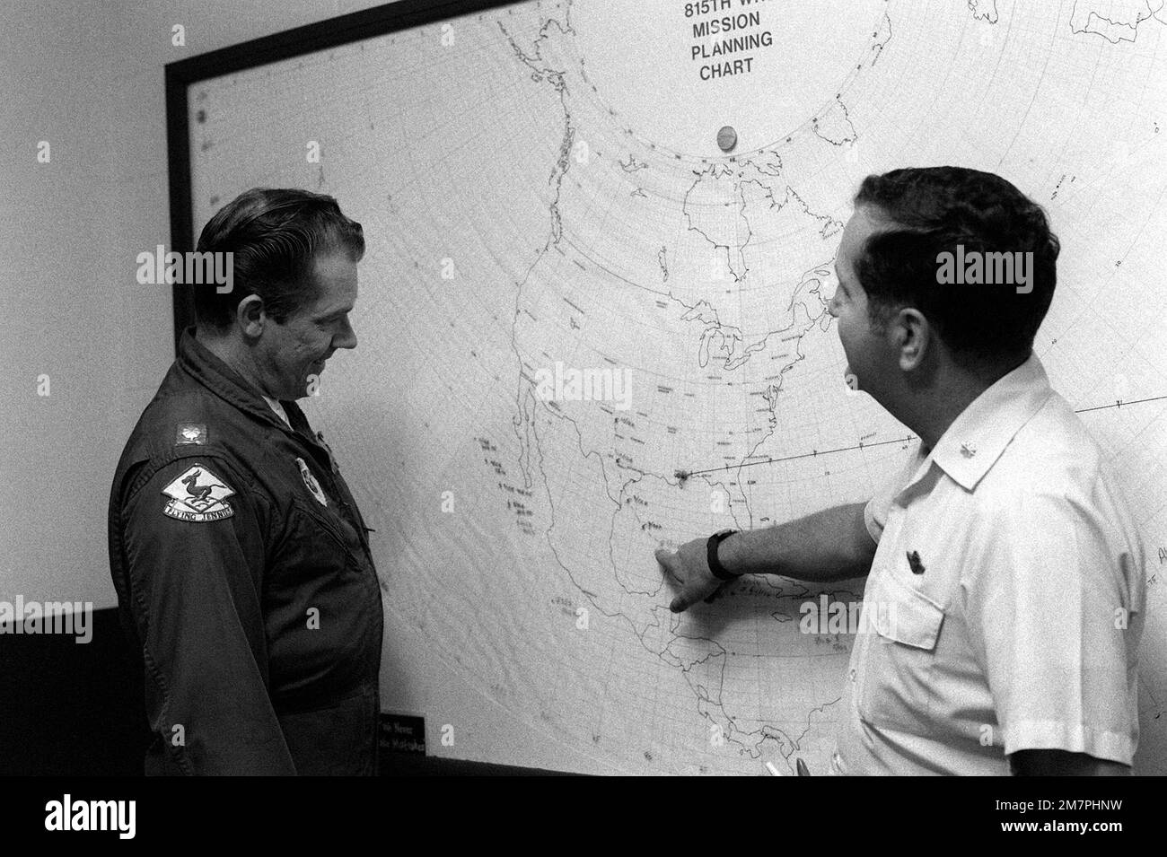 A weather station officer and an 815th Weather Reconnaissance Squadron WC-130 Hercules aircraft pilot examine a mission planning chart. The squadron is monitoring Hurrican Allen. Base: Keesler Air Force Base State: Mississippi (MS) Country: United States Of America (USA) Stock Photo