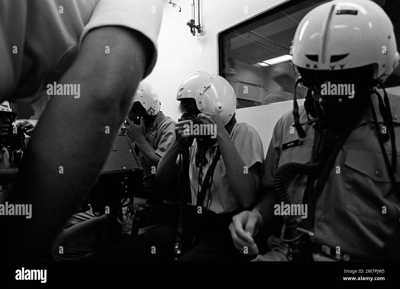 Midshipman Cindy Mason makes the final adjustments on her oxygen mask ...