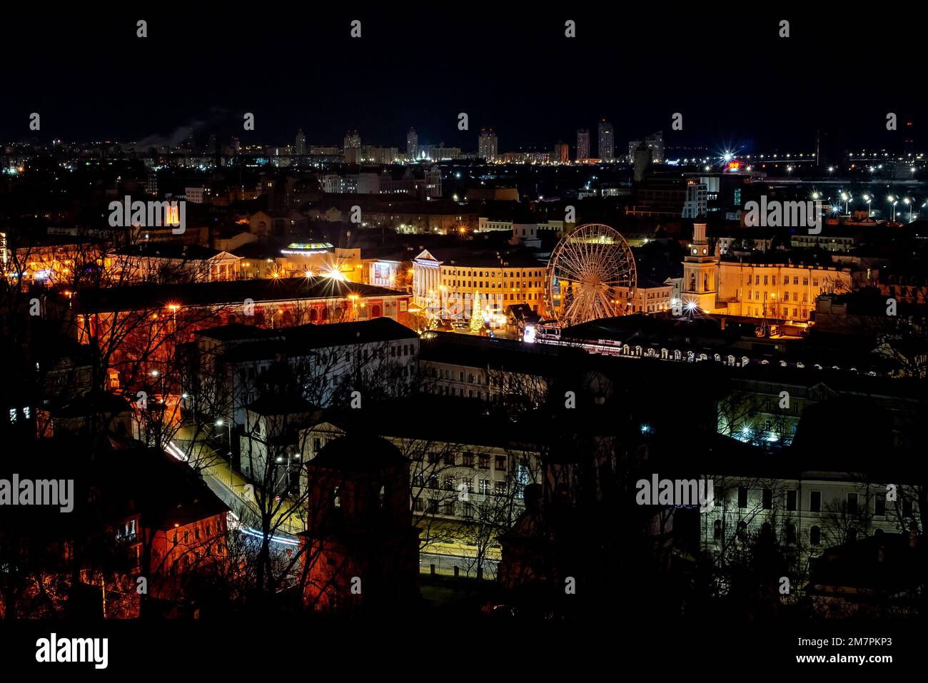 Kyiv, Ukraine - January 10, 2022: Night view of the city center. A bird's eye view of the Podil district in Kyiv. Ferris wheel. Peaceful New Year's Ky Stock Photo