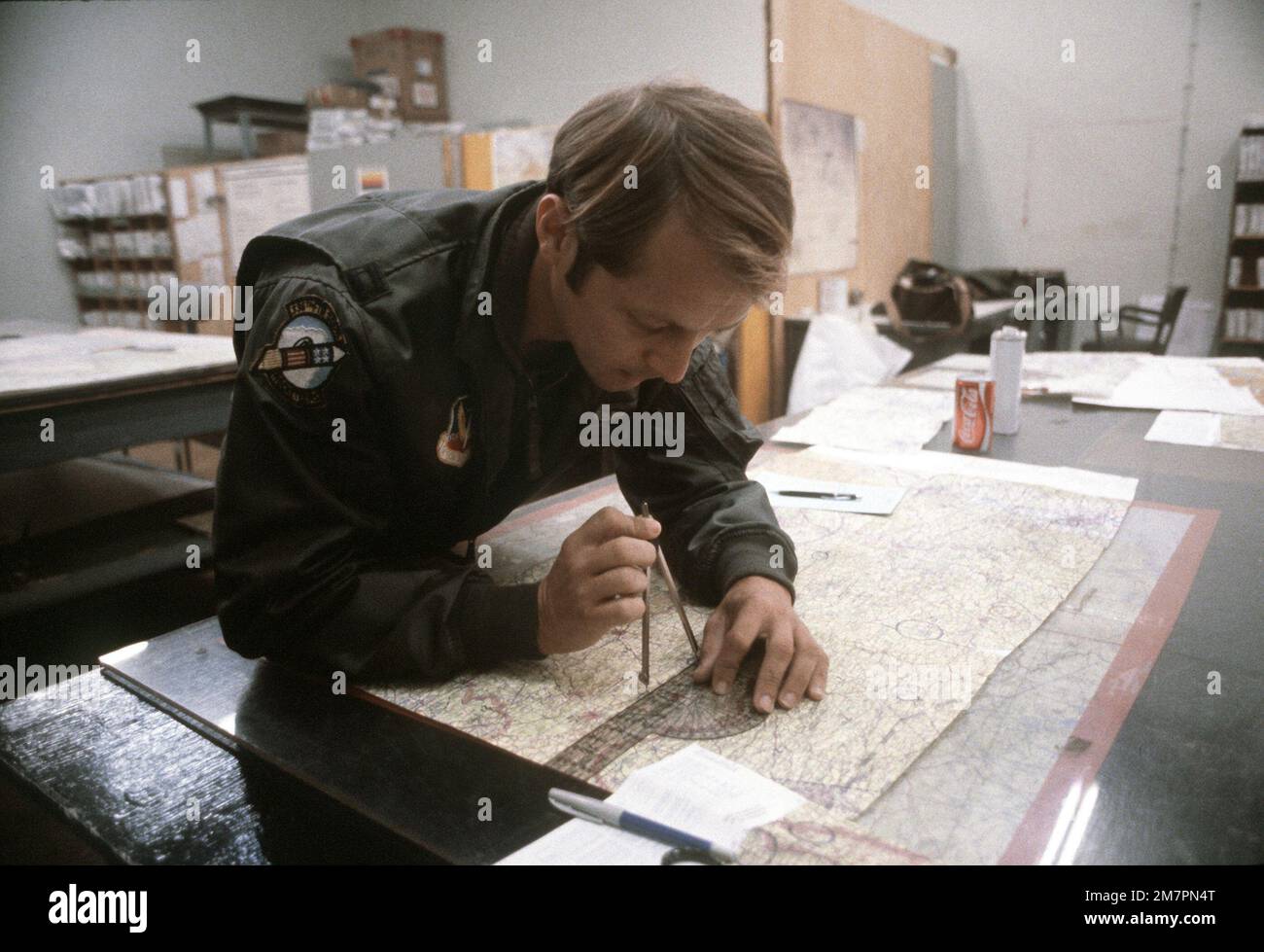 CPT Mark Wright, an F-4E Phantom II pilot of the 336th Tactical Fighter Squadron, charts a map during the exercise Crested Cap. Subject Operation/Series: CRESTED CAP Base: Ramstein Air Base State: Rheinland-Pfalz Country: Deutschland / Germany (DEU) Stock Photo