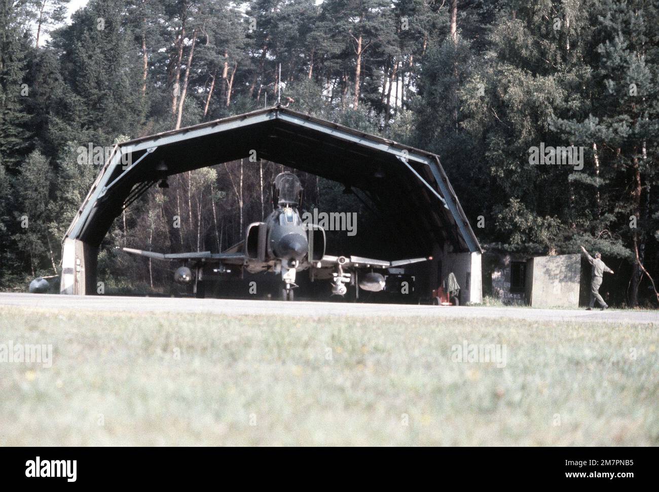Front view of an F-4E Phantom II aircraft of the 4th Tactical Fighter Wing taxiing out of a shelter during the exercise Crested Cap. Subject Operation/Series: CRESTED CAP Base: Ramstein Air Base State: Rheinland-Pfalz Country: Deutschland / Germany (DEU) Stock Photo