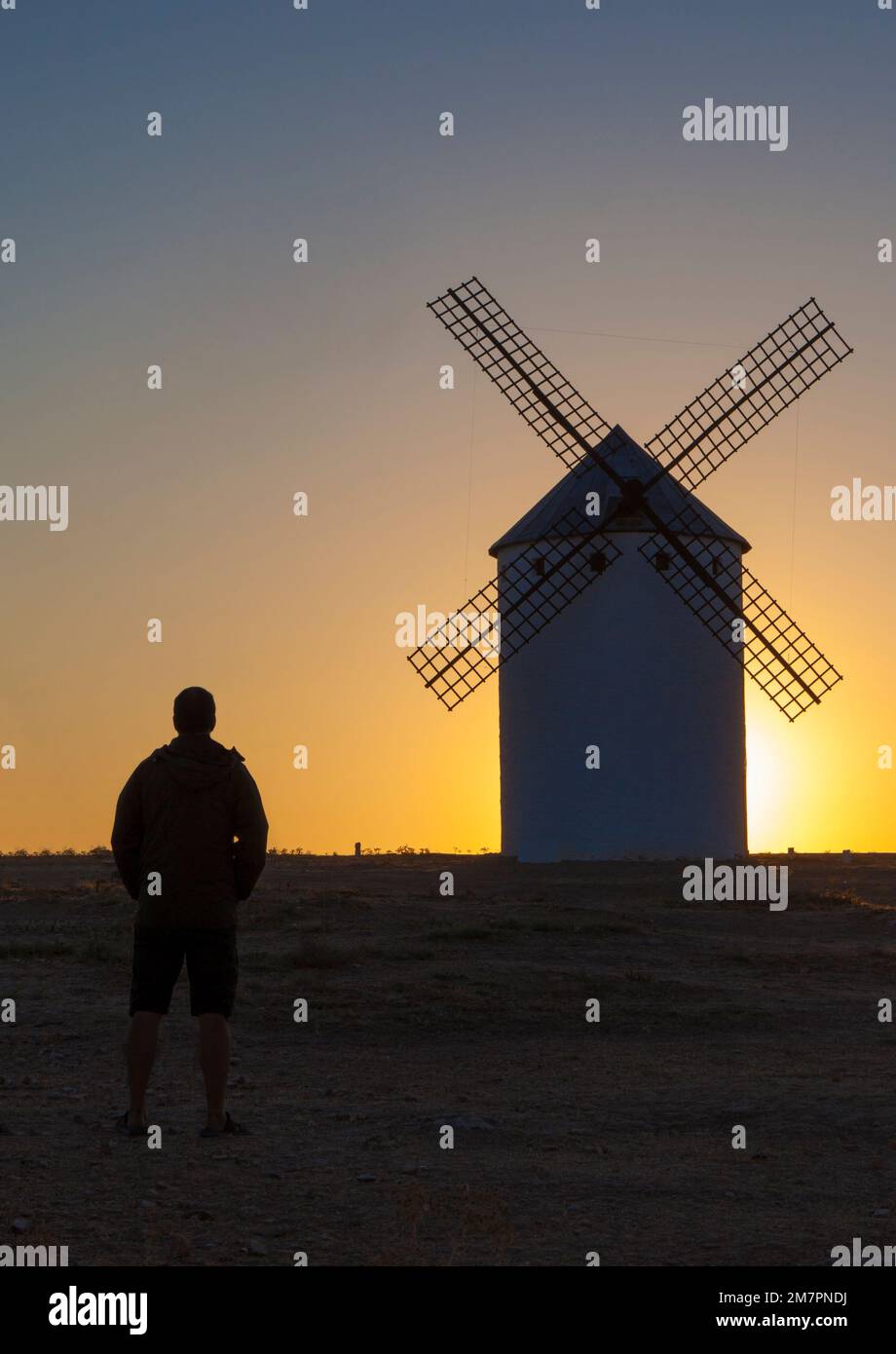 Man observing the Campo de Criptana windmills at rising through site, Spain. Ciudad Real, Spain Stock Photo