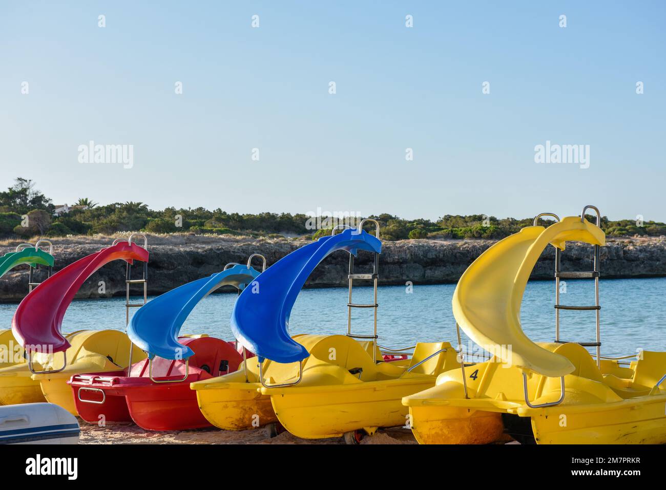 Paddle boats or pedalo lined up by the sea at the beach Stock Photo Alamy