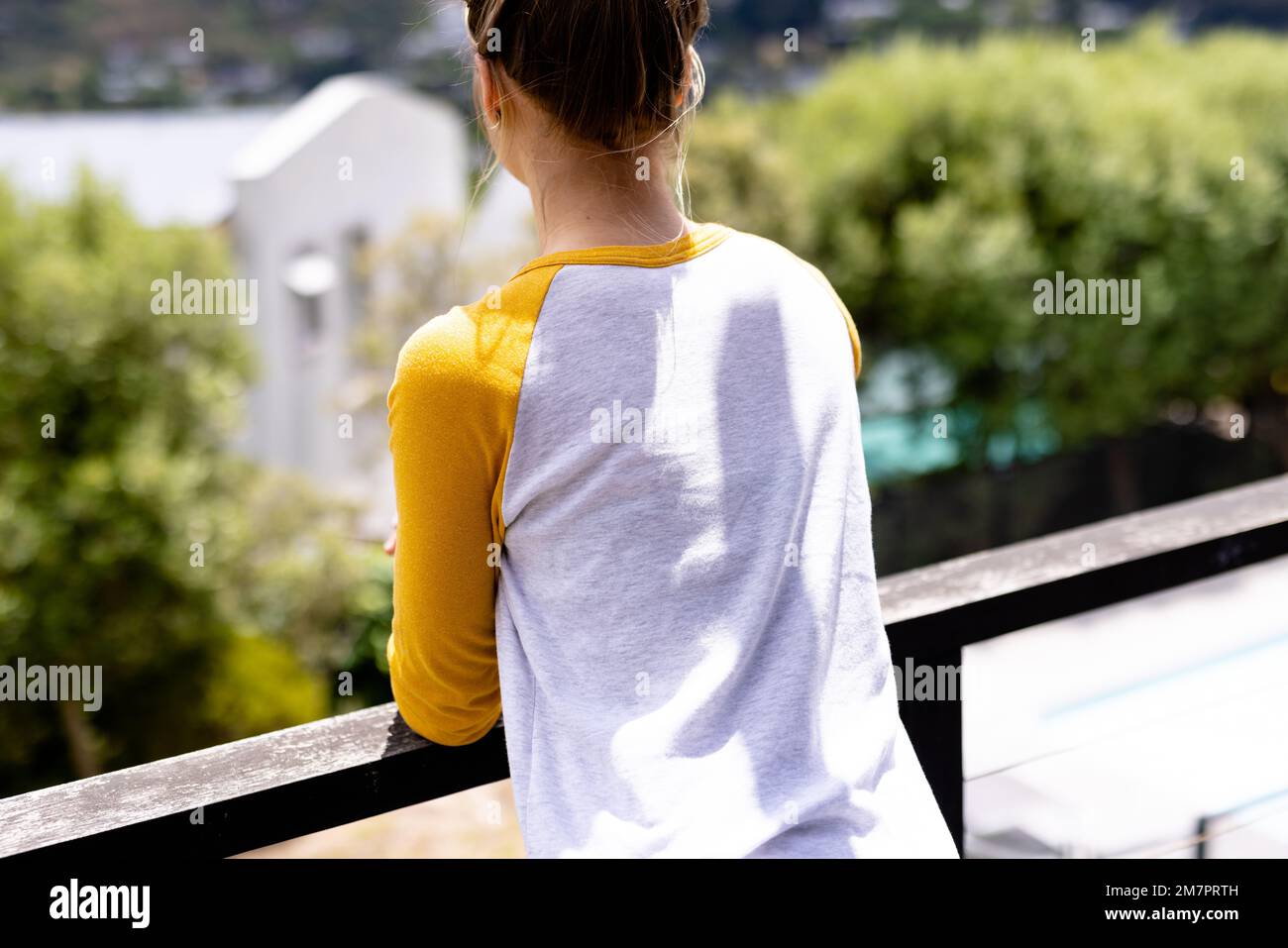 Image of caucasian woman in white and yellow long sleeve t shirt with copyspace Stock Photo