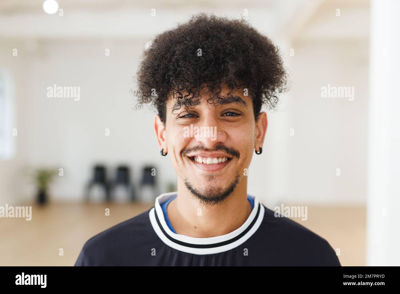 Image of happy biracial male hip hop dancer posing to camera Stock Photo