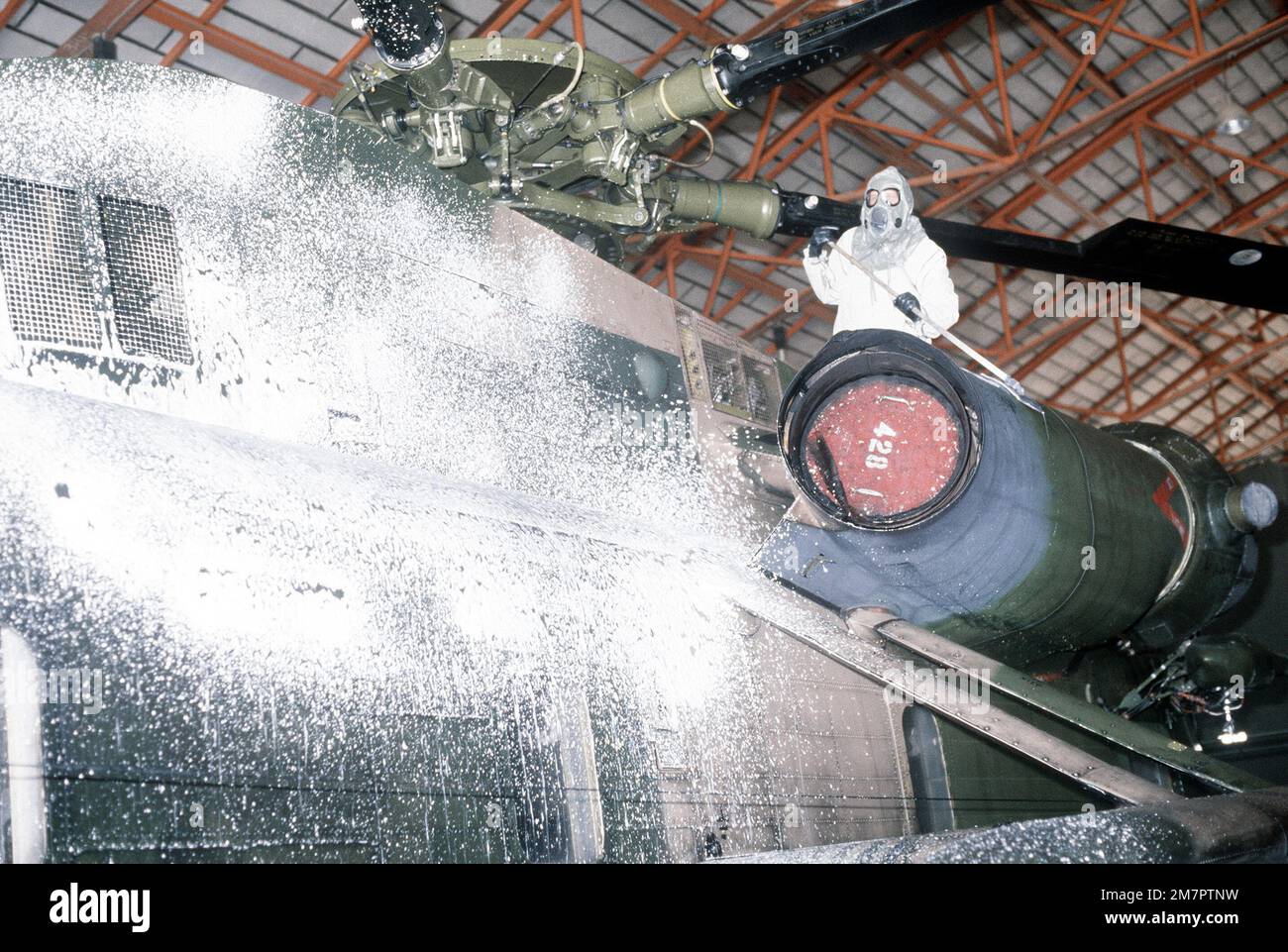 A ground crewman decontaminates an H-53 Sea Stallion helicopter during a chemical warfare training exercise. Base: Kirtland Air Force Base State: New Mexico (NM) Country: United States Of America (USA) Stock Photo