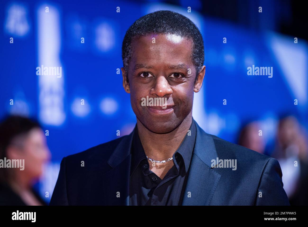 Adrian Lester poses for photographers upon arrival for 'The British