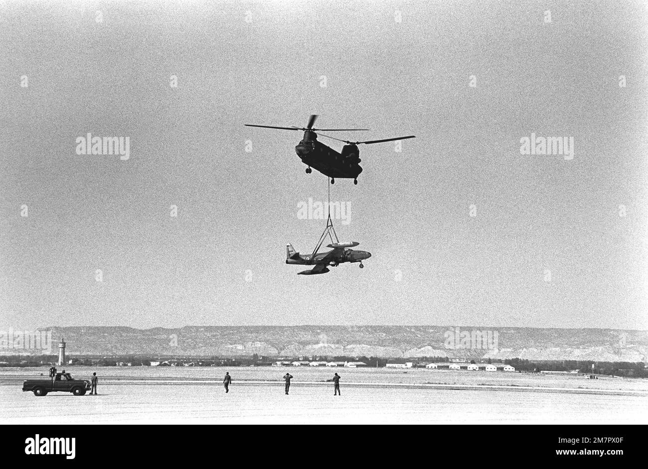 An Army CH-47 Chinook helicopter of the 205th Aviation Company delivers a French T-33 Shooting Star aircraft to be used as a battle-damaged aircraft for quick turn-around maintenance training. The Spanish government would not permit the delivery of the aircraft to any other base in Spain. Base: Zaragosa Air Base Country: Spain (ESP) Stock Photo