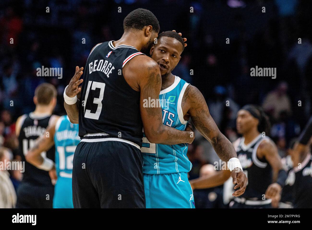 LA Clippers guard Paul George (13) hugs Charlotte Hornets guard Terry Rozier after an NBA basketball game on Monday, Dec
