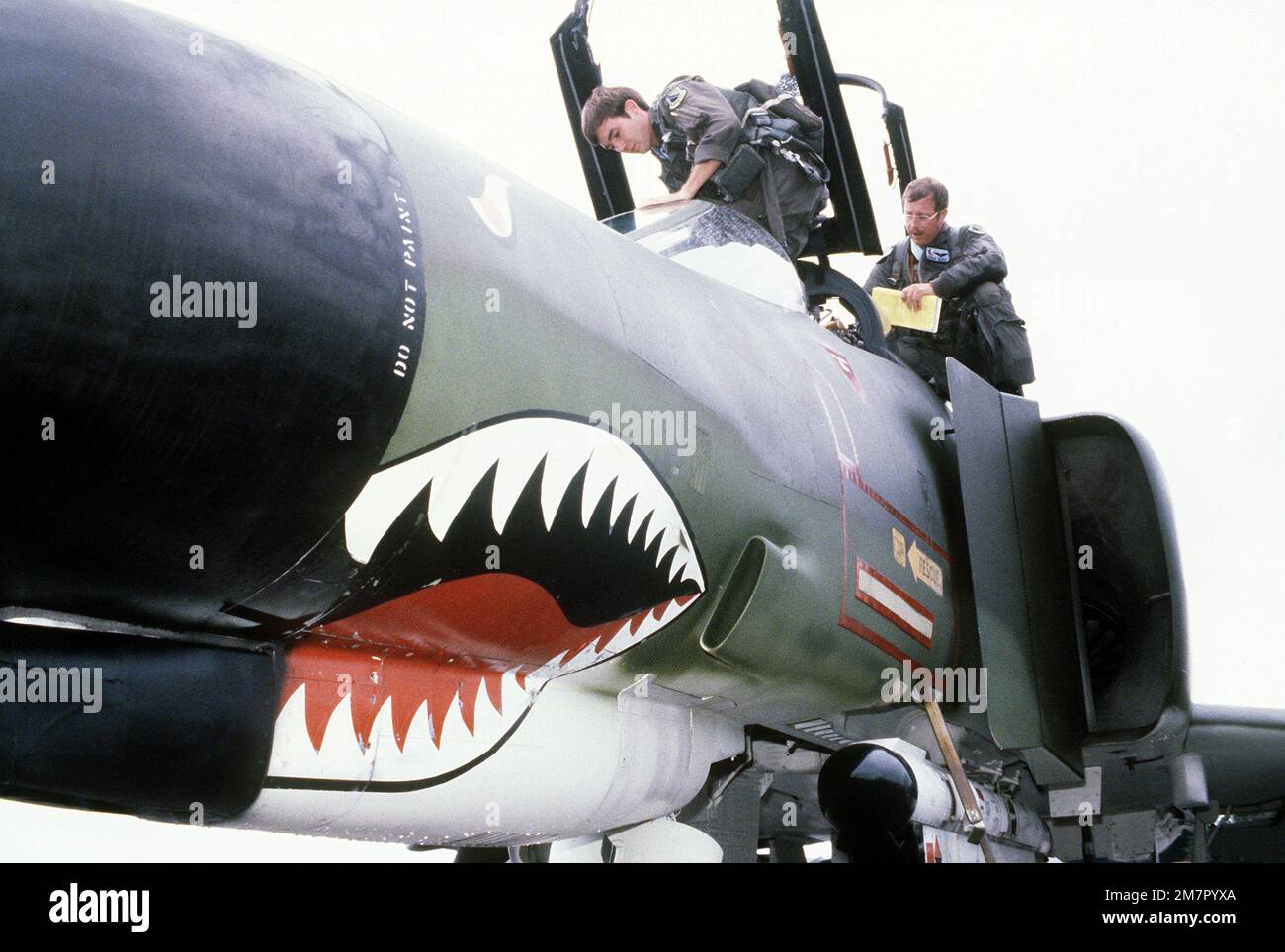 F-4E Phantom II aircraft pilots board their aircraft during exercise Cope North '80. The pilots are assigned to the 3rd Tactical Fighter Wing. Subject Operation/Series: COPE NORTH '80 Base: Naval Air Facility, Misawa State: Aomori Country: Japan (JPN) Stock Photo