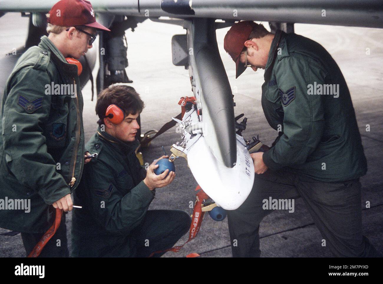 Members of the 3rd Tactical Fighter Wing load practice bombs on an F-4E Phantom II aircraft during exercise Cope North '80. Subject Operation/Series: COPE NORTH '80 Base: Naval Air Facility, Misawa State: Aomori Country: Japan (JPN) Stock Photo