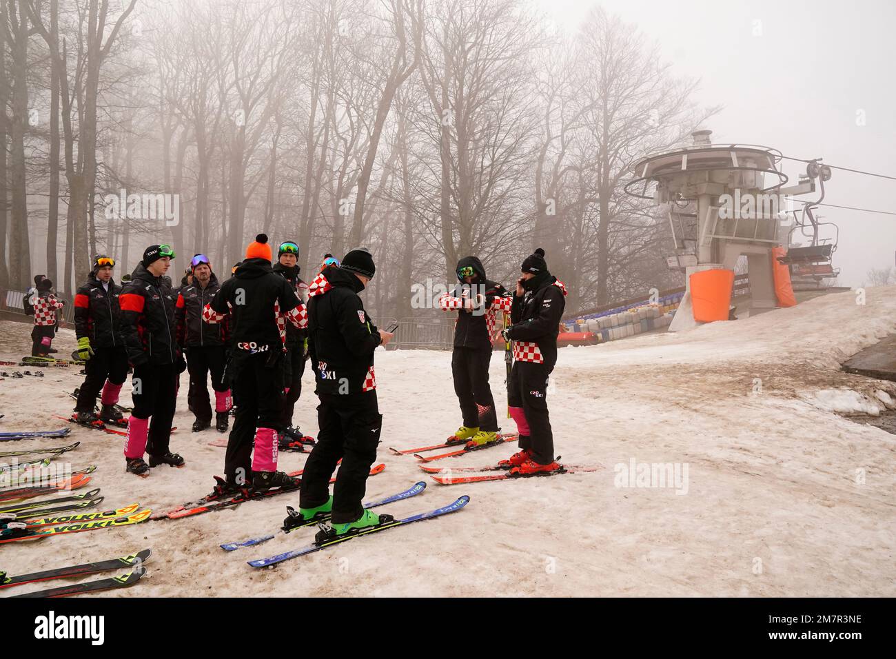 Course technicians stand near the start as an alpine ski, women's World