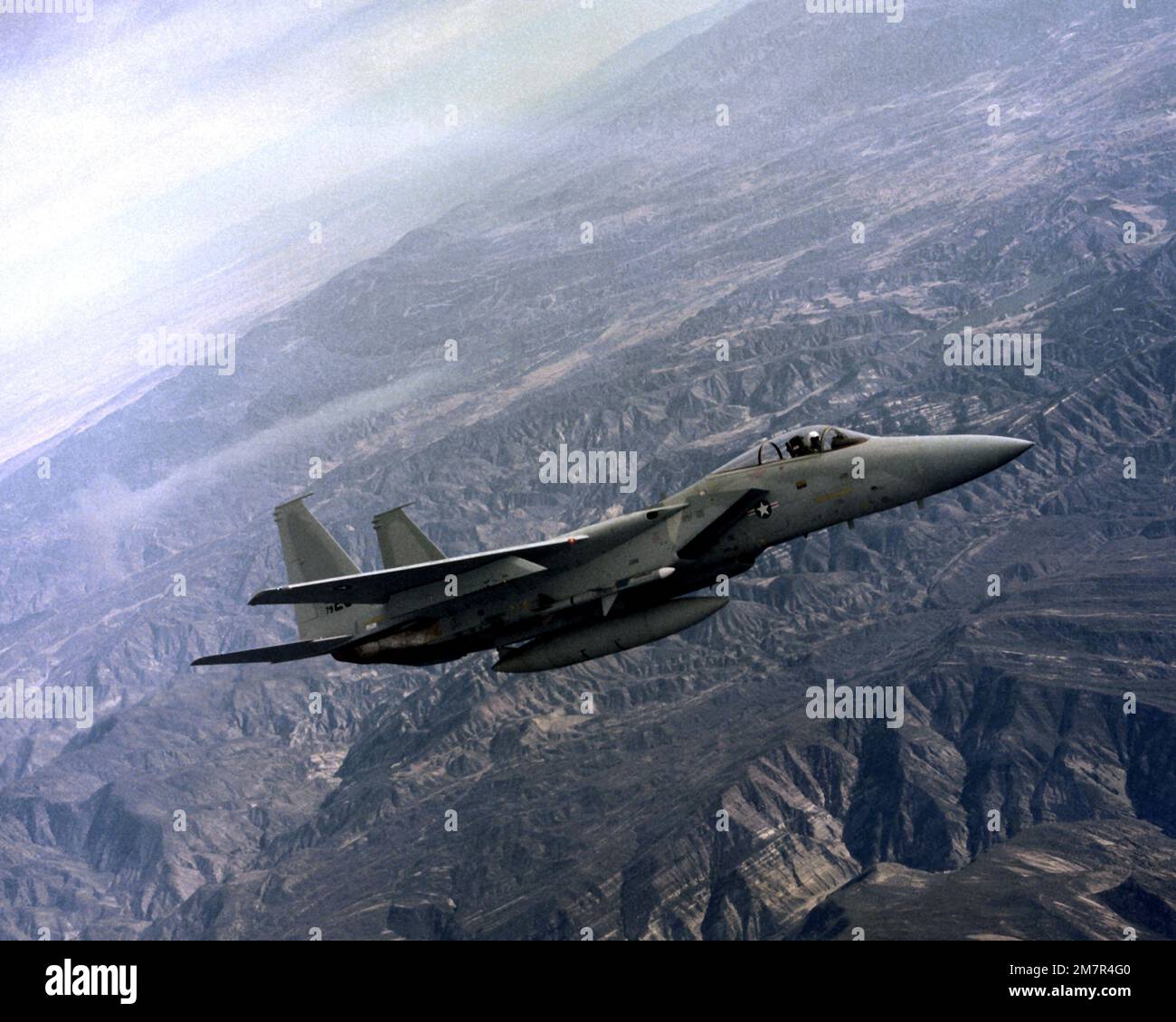 An air-to-air right side view of an F-15J Eagle aircraft with an AIM-7F Sparrow missile mounted on the forward fuselage missile well. Base: Pacific Missile Test Center State: California (CA) Country: United States Of America (USA) Stock Photo