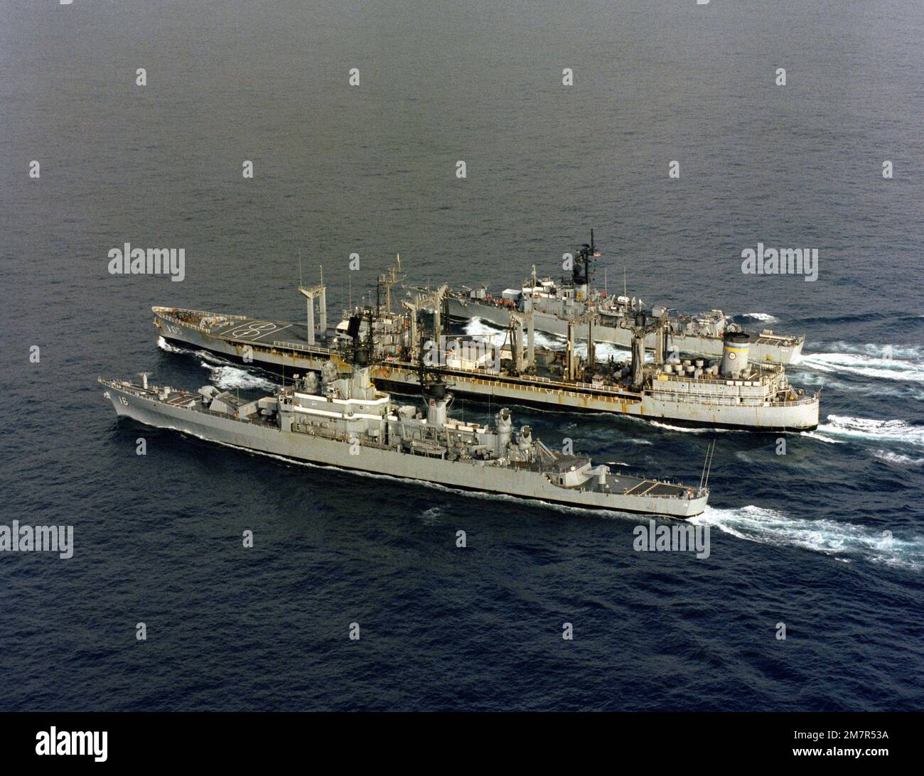 An aerial port quarter view of, front to back: the guided missile ...