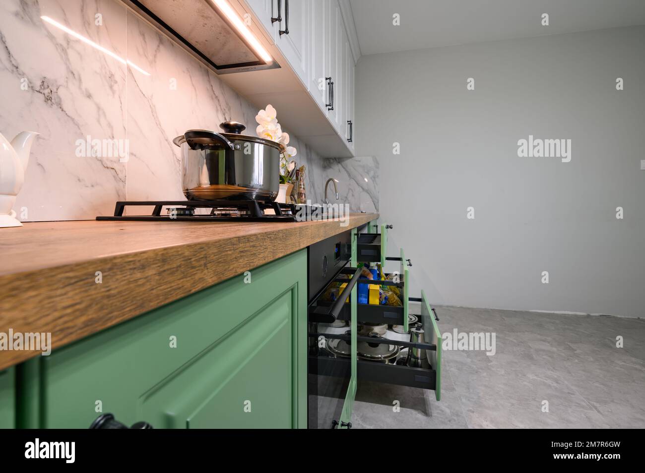 Green and white colored modern kitchen details closeup Stock Photo