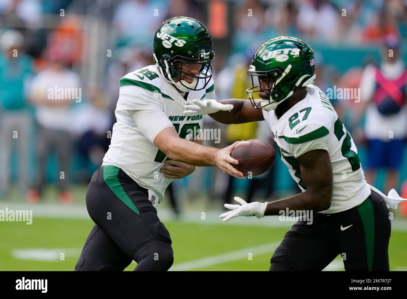 New York Jets quarterback Joe Flacco (19) hands off to running back Zonovan  Knight (27) during the first half of an NFL football game against the Miami  Dolphins, Sunday, Jan. 8, 2023,