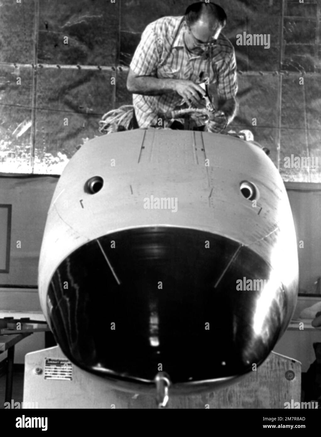 A workman performs maintenance on an F-5G Tiger II aircraft forward