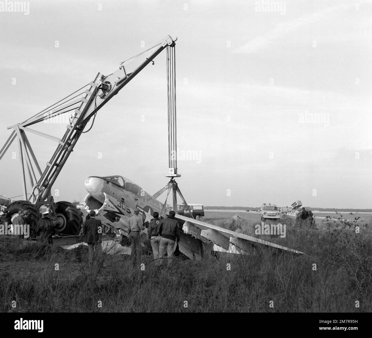 An aircraft crane is used to hoist an attack squadron 66 va 66 a 7e