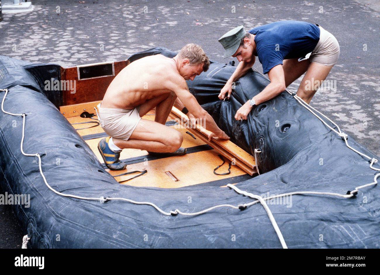 Navy Target Raft Navy personnel prepare a rubber raft for rigging prior to loading it ...