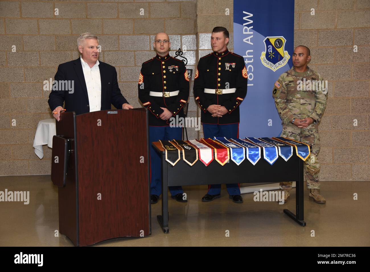 Sioux City, Iowa Chamber of Commerce president Chris McGowan, U.S Marine  Corps Staff Sgt. Jonathan Bach, Staff Sgt. Blake Smolinski and Army Maj.  Robin Labios stand in front of a table of