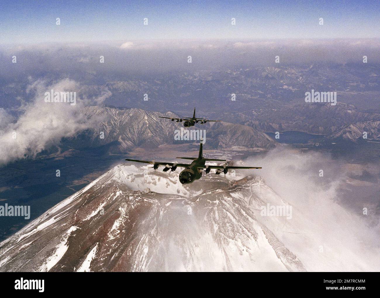 An air-to-air front view of two C-130 Hercules aircraft from the 345th Tactical Airlift Squadron over Mount Fugi. Country: Japan (JPN) Stock Photo