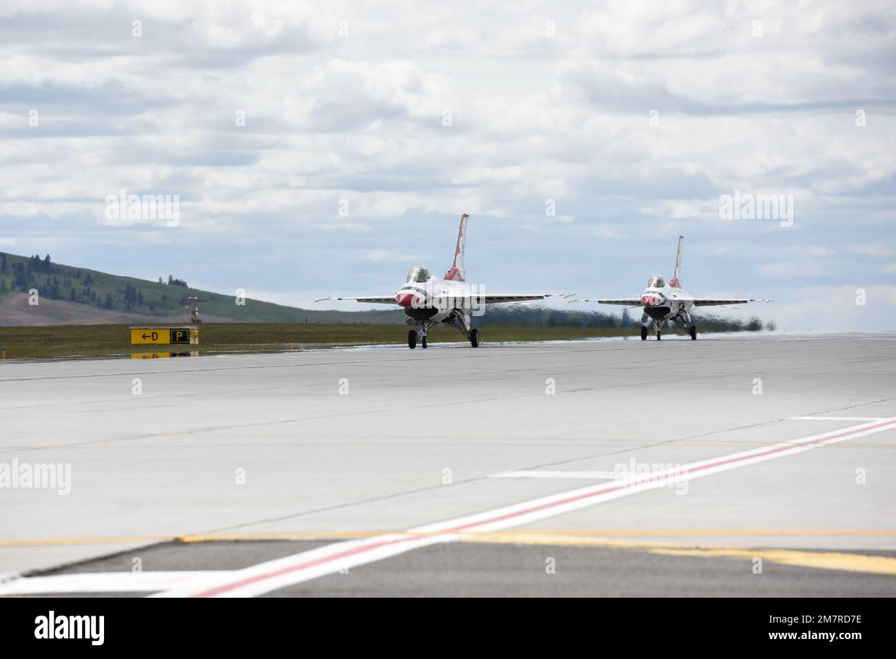 Two U.S. Air Force Thunderbirds land after practicing for Skyfest 2022 at Fairchild Air Force