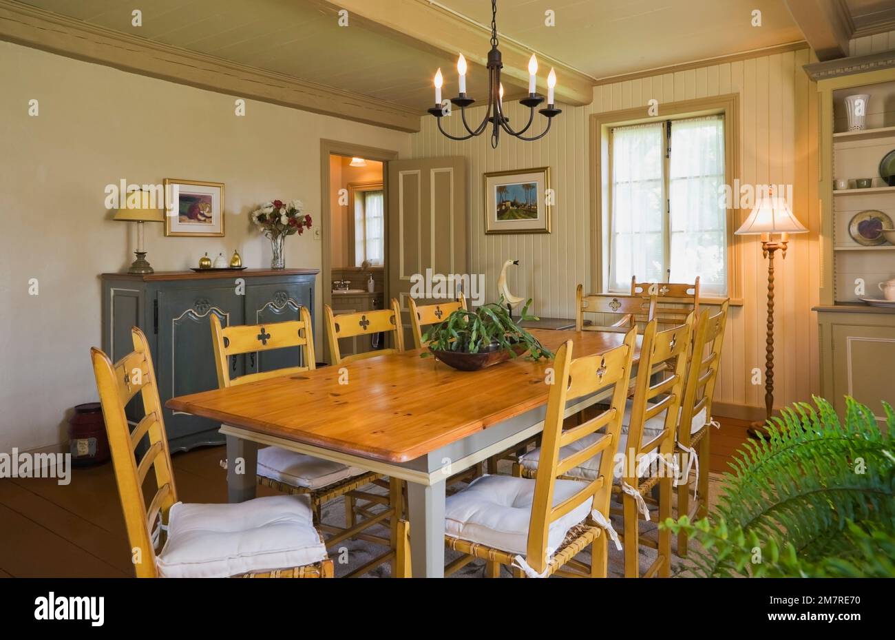Antique wooden table and chairs in dining room inside old reconstructed 1850s cottage style log