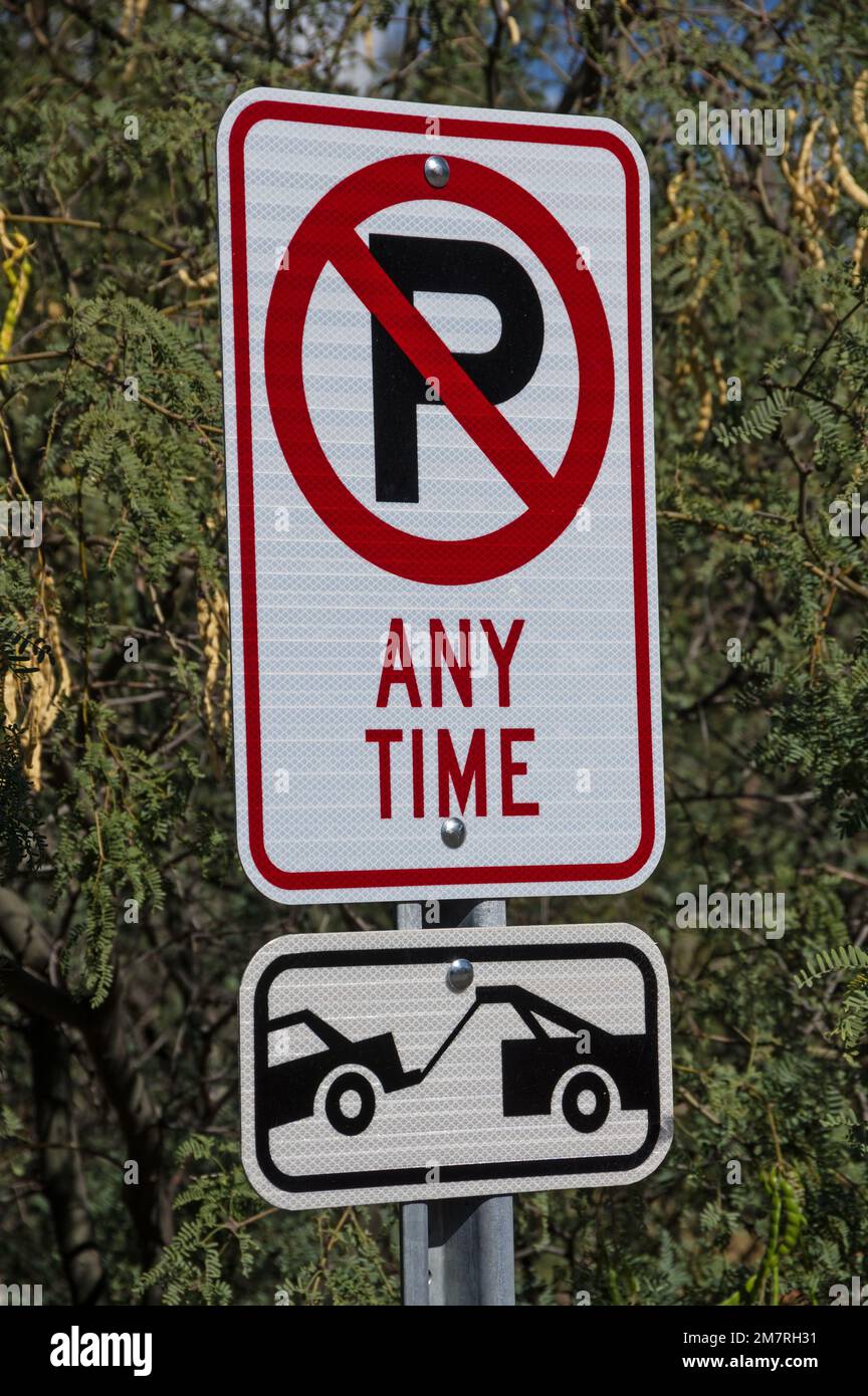 no parking sign with P with red line and tow truck graphic Stock Photo