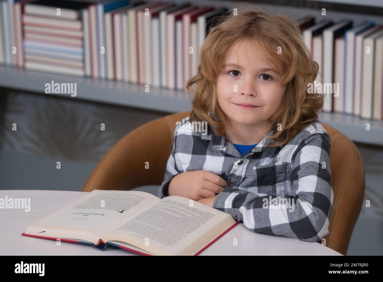 Education, knowledge and bookstore concept. Cute school kid studying in