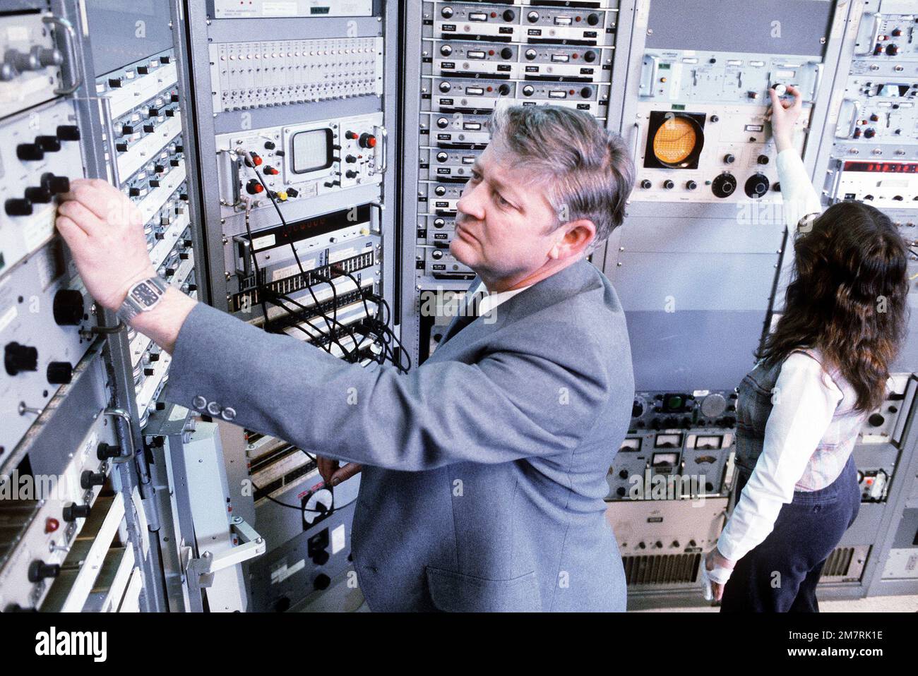 An engineer works with a computer panel in the telemetry ground ...