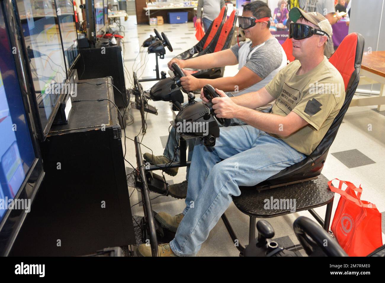 Attendees at Health and Safety Awareness Day use a distracted driving simulator wearing goggles to simulate the effects of alcohol on May 12, 2022, at Fort Indiantown Gap, Pa. (Pennsylvania National Guard photo by Brad Rhen) Stock Photo