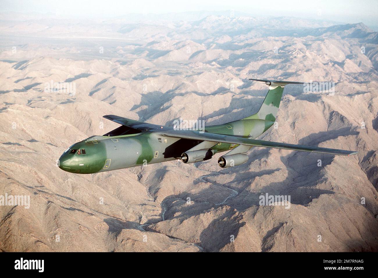 AN air-to-air left front view of a C-141B Starlifter aircraft with the ...