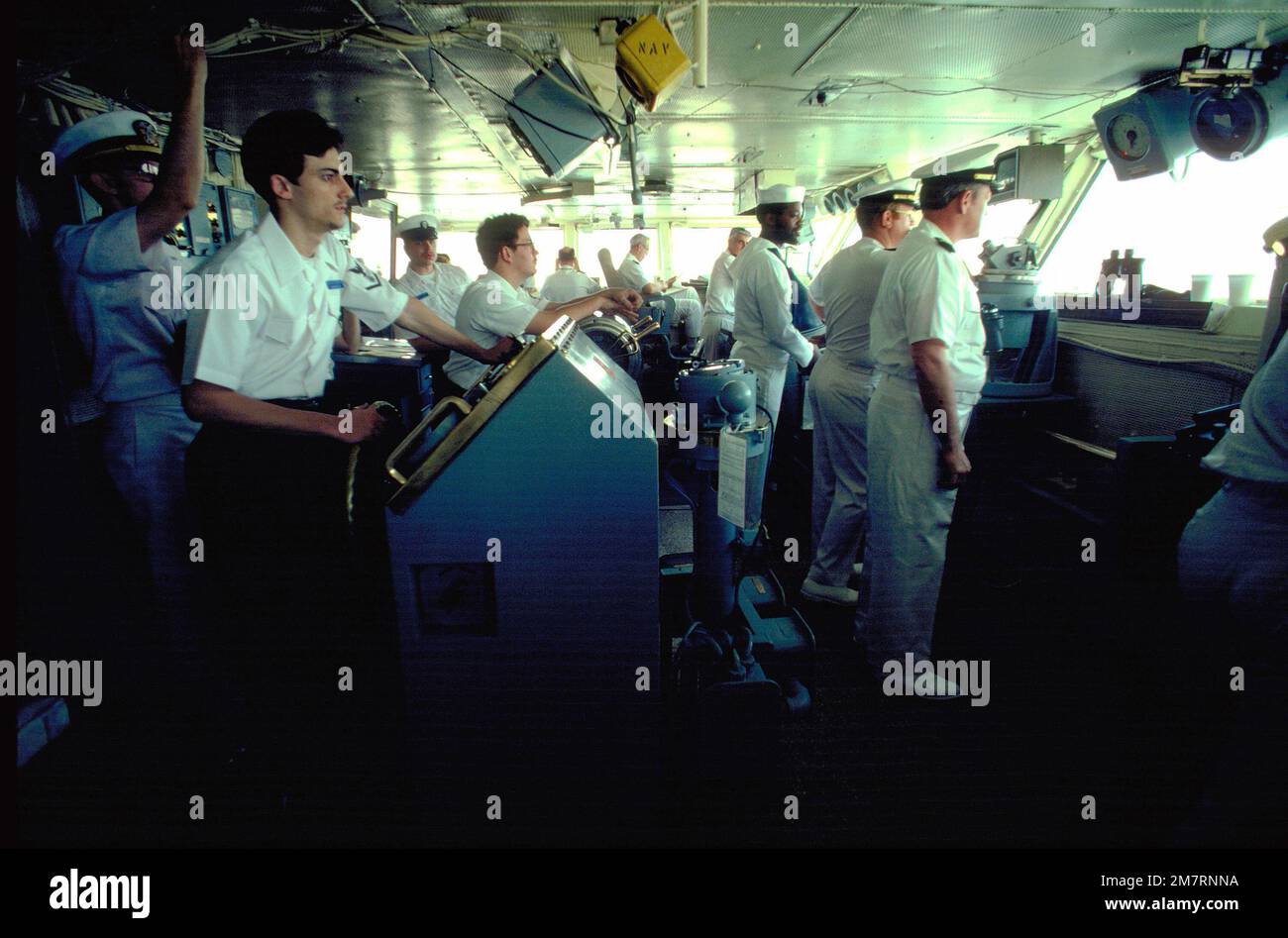 Officers and crewmen perform their duties on the bridge of the aircraft