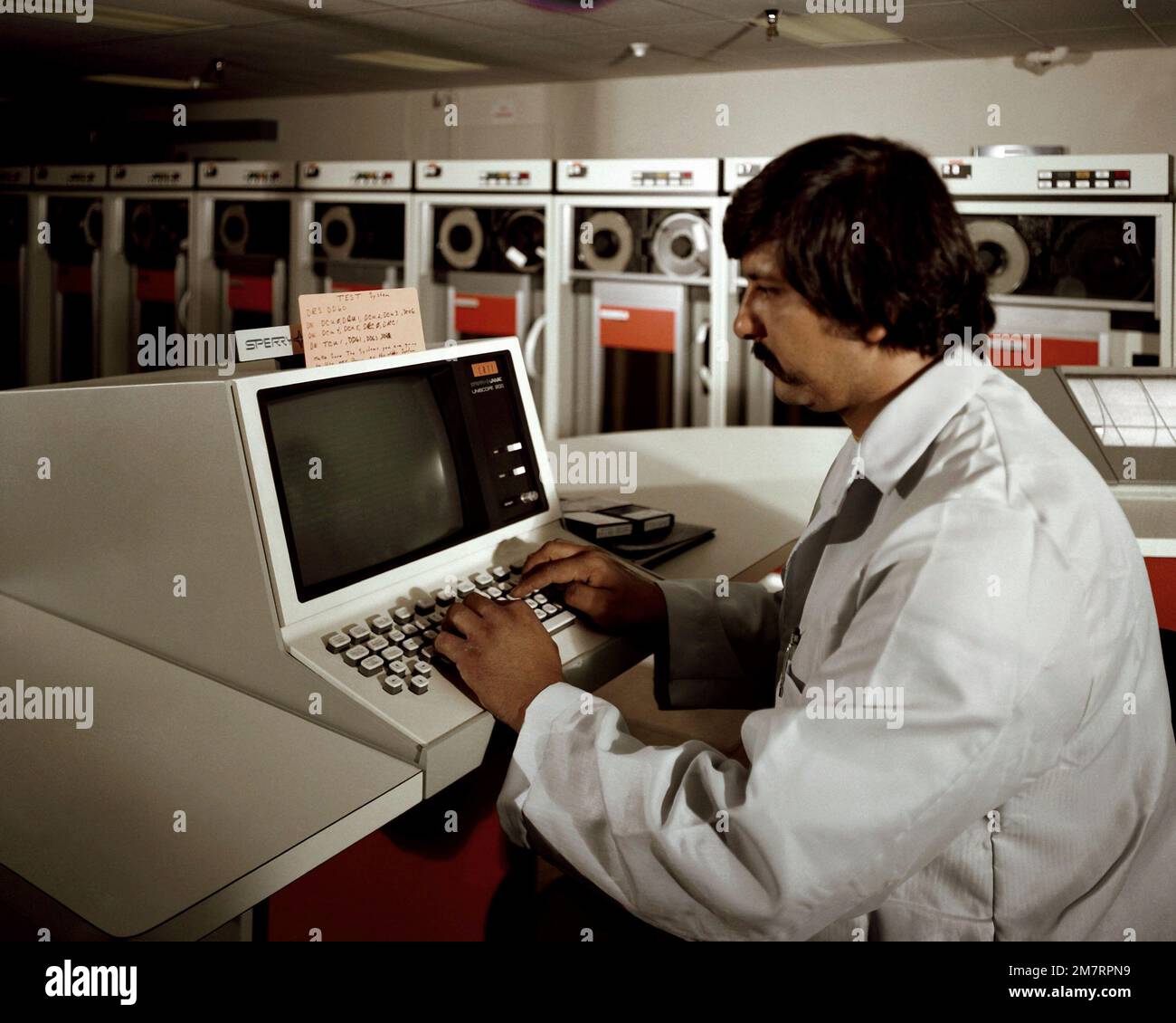 A technician operates the system console on the new UNIVAC 1100/83 computer at the Fleet Analysis Center, Corona Annex, Naval Weapons Station, Seal Beach, California. Base: Corona State: California (CA) Country: United States Of America (USA) Stock Photo