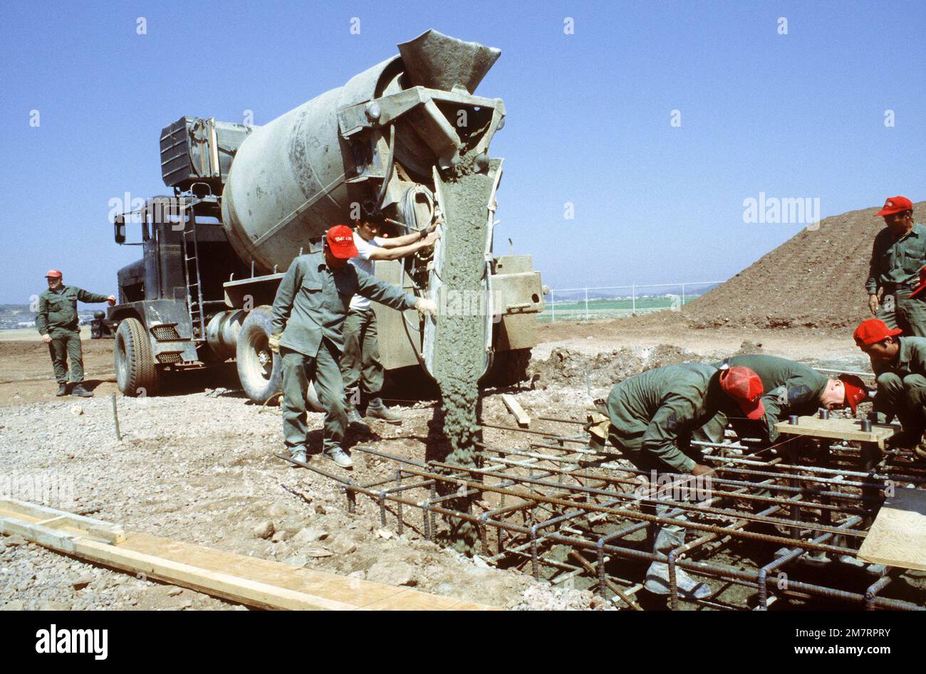 Members of the 554th Civil Engineering Squadron (Red Horse) pour