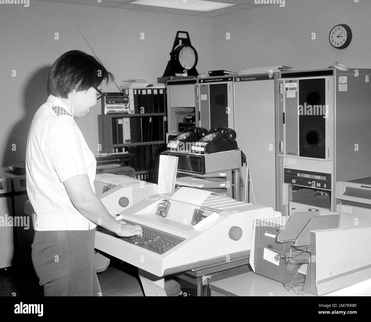 Captain Sally Wu operates a data processing terminal at the ...