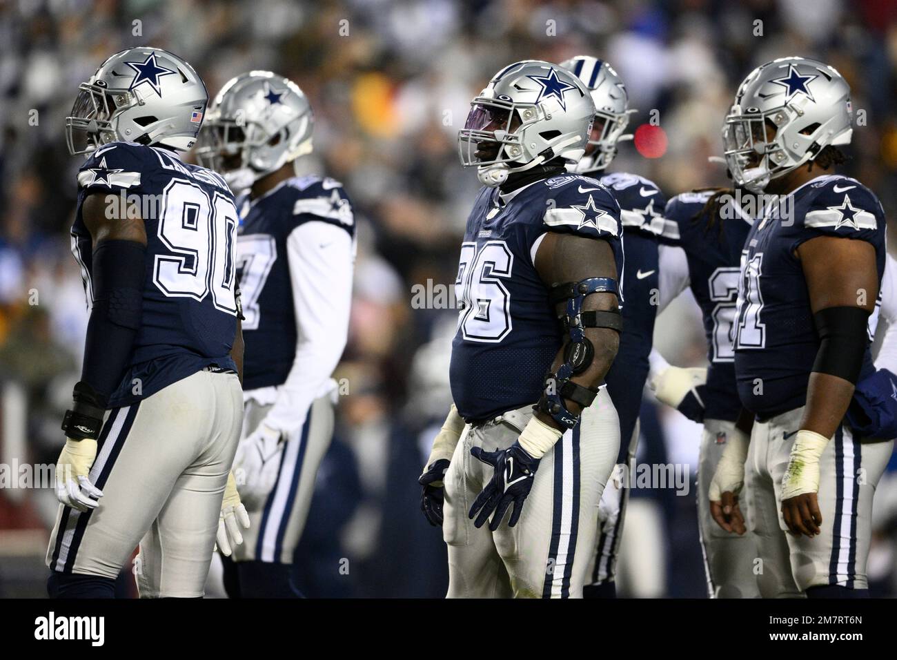 The Dallas Cowboys stand on the field during the first half of an