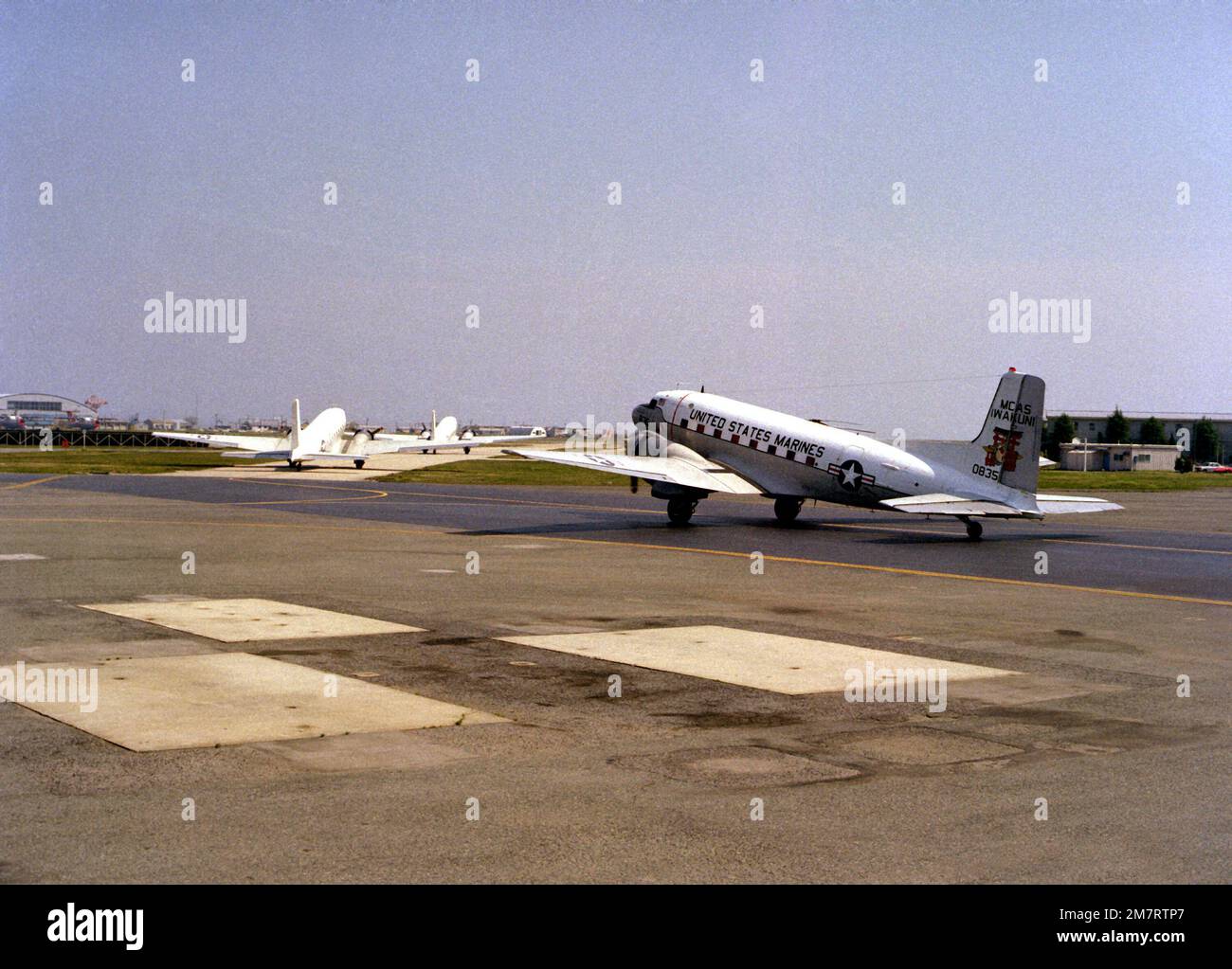 Three of four Marine C-117 aircraft taxi to the runway to prepare for ...