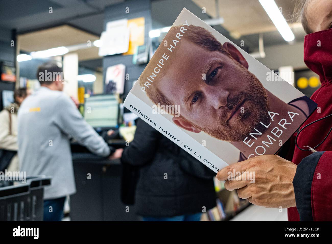 Barcelona, Spain. 10th Jan, 2023. A woman is seen holding the spanish edition of Prince Harry's memoir book, entitled "En la Sombra", original title "Spare", inside an "Abacus" bookstore in the city center. Credit: SOPA Images Limited/Alamy Live News Stock Photo