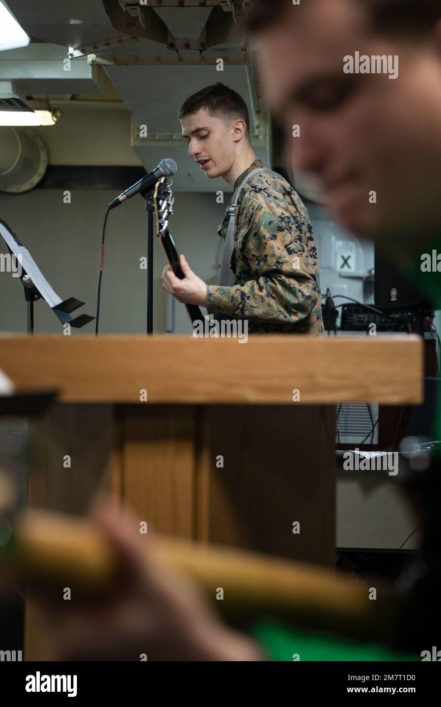 ATLANTIC OCEAN (May 12, 2022) – U.S. Marine Corps Lance Cpl. Joseph Andreen plays guitar and sings during the chapel’s band-practice aboard the Wasp-class amphibious assault ship USS Kearsarge (LHD 3), May 12, 2022. Kearsarge, flagship of the Kearsarge ARG/MEU team, is on a scheduled deployment under the command and control of Task Force 61/2 while operating in U.S. Sixth Fleet in support of U.S., Allied and partner interests in Europe and Africa. Stock Photo